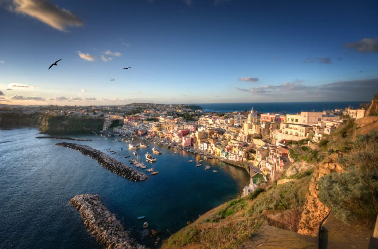 Marina Corricella in Procida with pastel houses and fishing boats