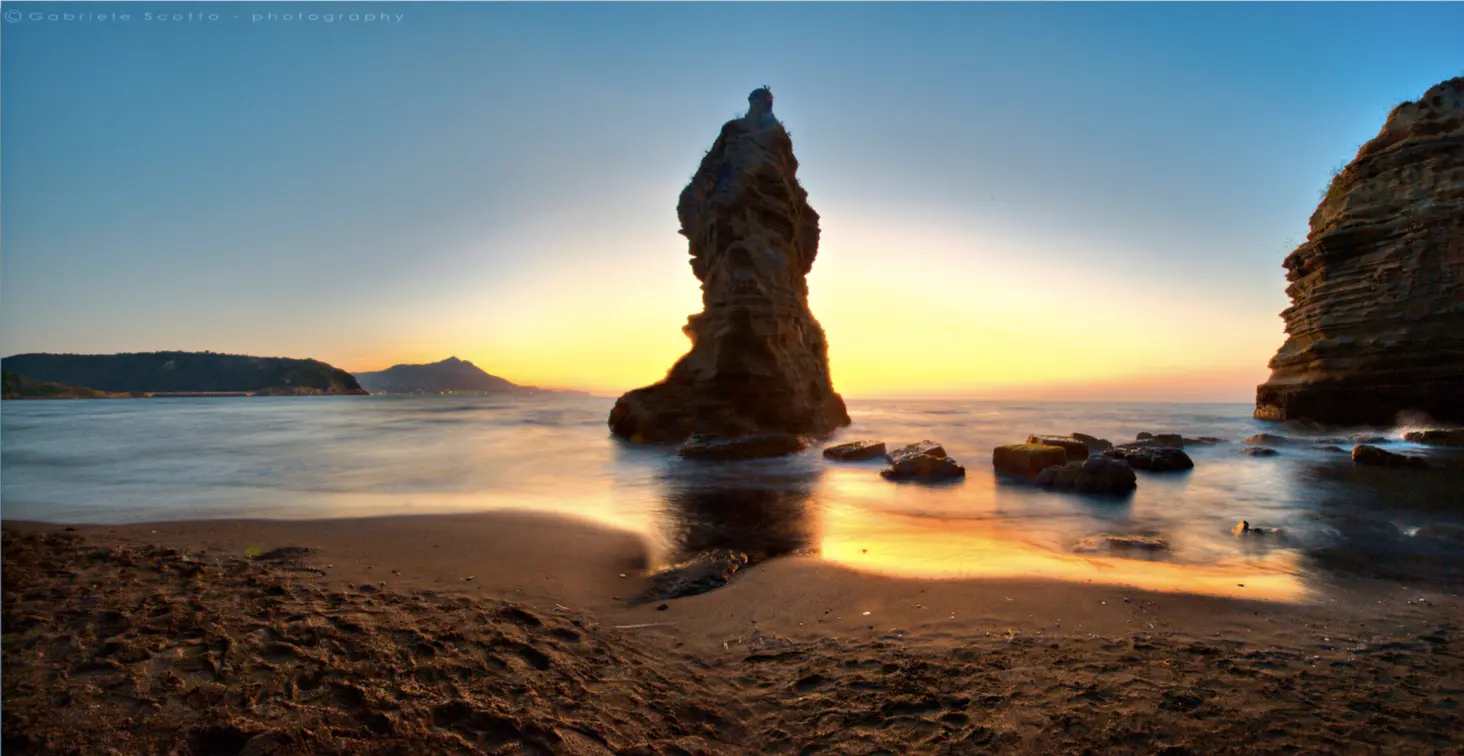 Chiaiolella beach in Procida at sunset with Vivara nearby